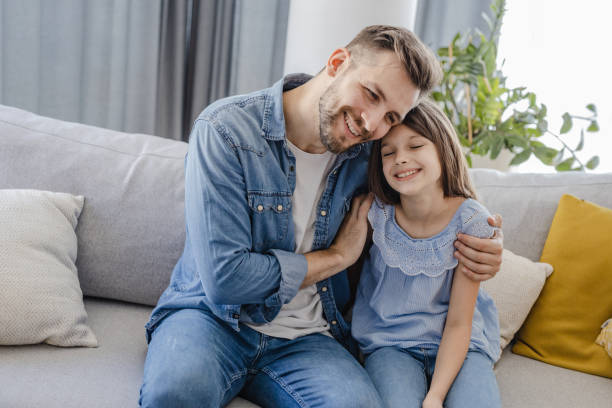 istock Father and daughter at home on the couch 1337841483
