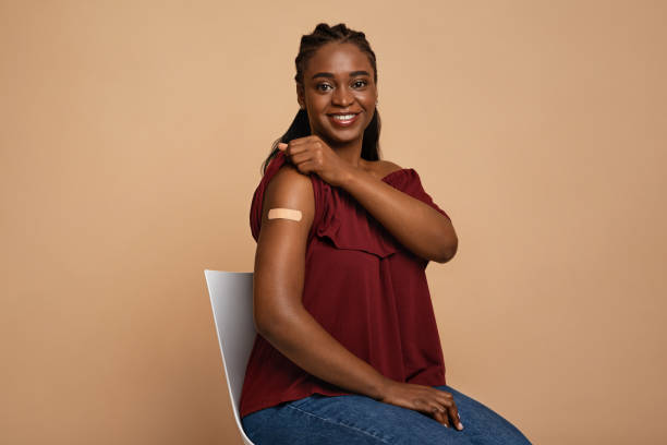 istock Happy black lady showing shoulder after vaccination 1337841620