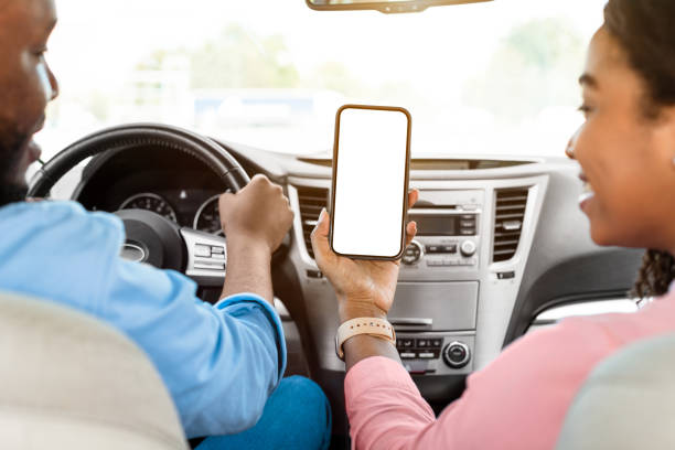 istock Happy African couple using showing smartphone with empty screen 1337841959