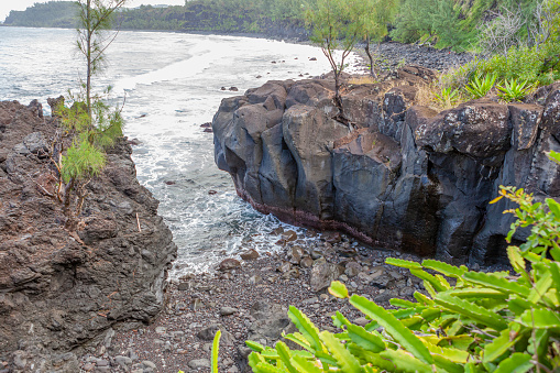 Riviere Langevin - Reunion Island, the volcanic black rocks the exhuberant vegetation and the intense turqoise blue water.