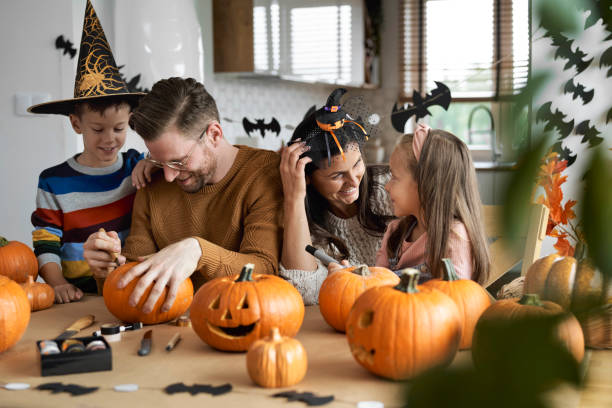 istock Happy family making jack-o-lantern 1337843730