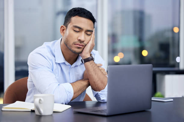 istock Shot of a businessman looking exhausted at work 1337844046