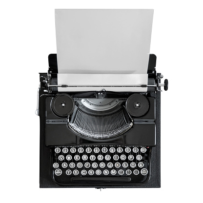 antique black typewriter with empty clamped white paper against a white background