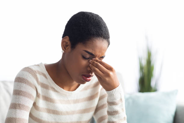 sinusitis concept. sick young black woman touching her nose bridge at home - communicable disease imagens e fotografias de stock