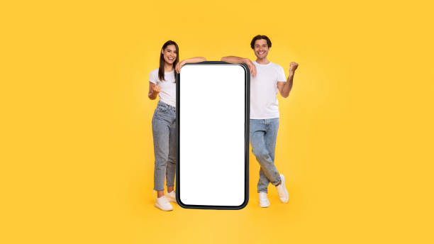 istock Couple showing white empty smartphone screen and gesturing yes 1337848290