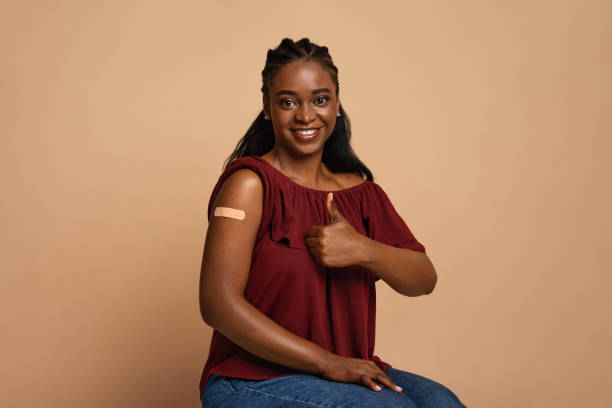 istock Cheerful black lady recommending vaccination against coronavirus 1337854121