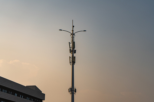 5G signal tower in the sunset