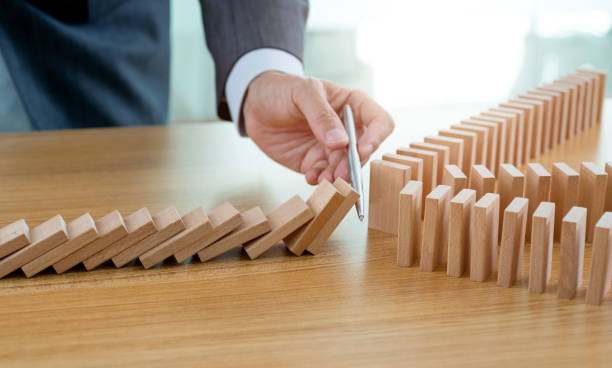 istock Businessman hand stop domino effect 1337857890