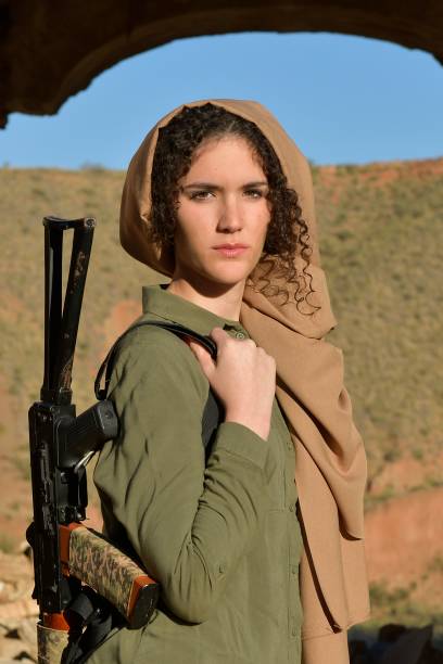 istock Young woman armed with an AK-47. 1337858015