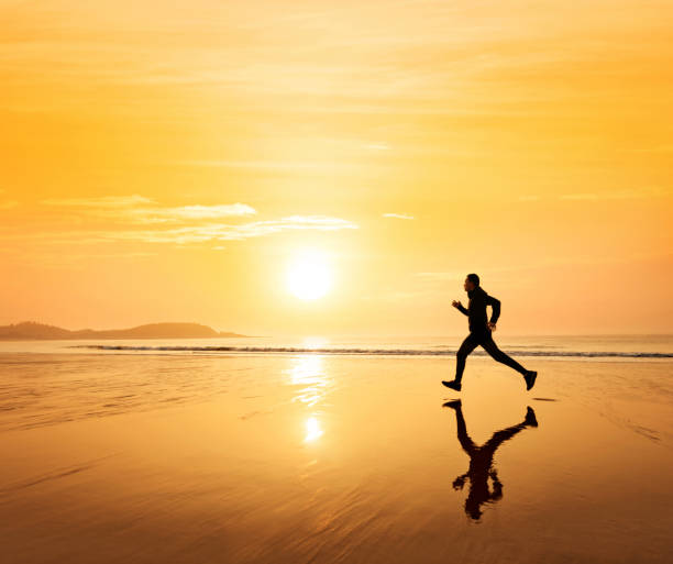 istock Man running on the golden beach 1337858081