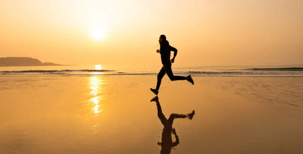 istock Man running on the golden beach 1337858117