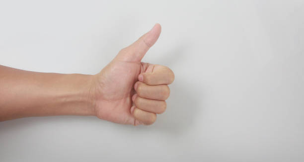 istock Hand showing thumbs up sign against 1337858877