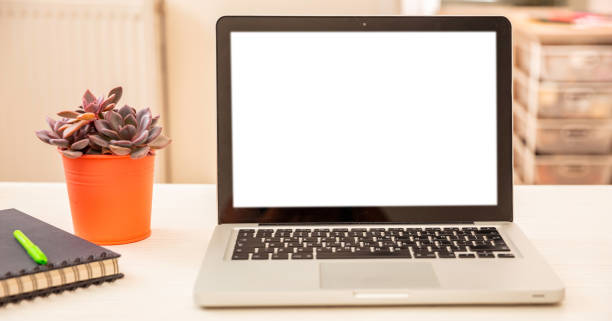istock Blank screen computer laptop on a white office desk, room interior background, space, template. 1337868432