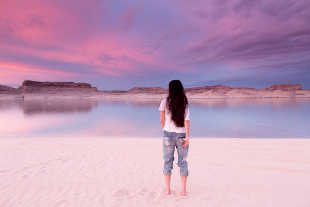 Woman at Lake Powell Woman standing looking at the dusk view in Lake Powell, Urah. lake powell stock pictures, royalty-free photos & images