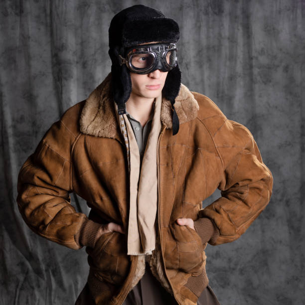 istock Pilot aviator in retro style, a young man in a flight jacket and glasses, 1337875173