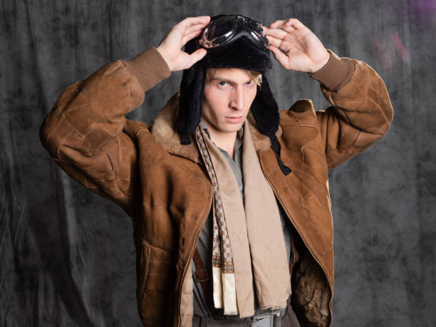 istock Pilot aviator in retro style, a young man in a flight jacket and glasses, 1337875184