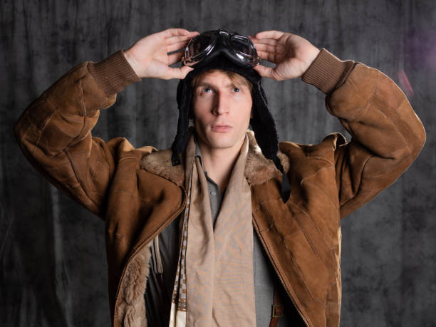 istock Pilot aviator in retro style, a young man in a flight jacket and glasses, 1337875195