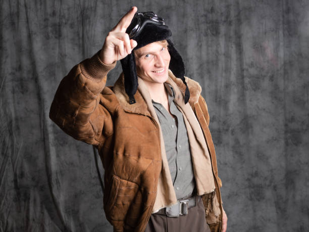 istock Happy smiling aviator pilot in retro style, a young man in a flight jacket 1337875206