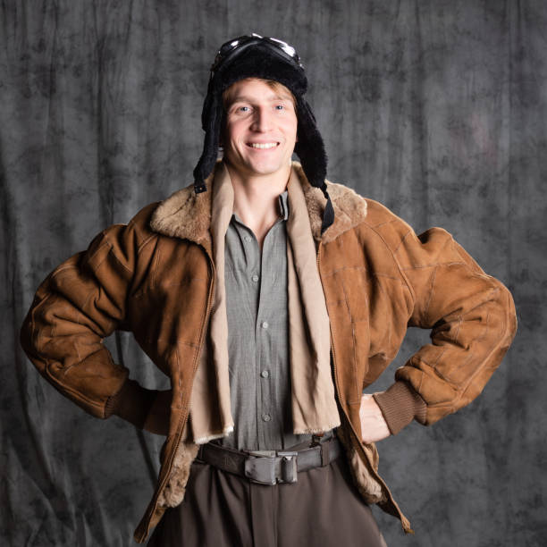 istock Happy smiling aviator pilot in retro style, a young man in a flight jacket 1337875216