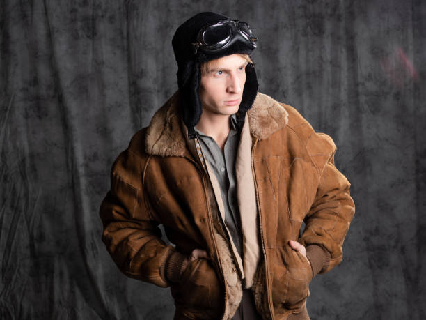 istock Retro style aviator in a flying hat with goggles. Young attractive man 1337875224