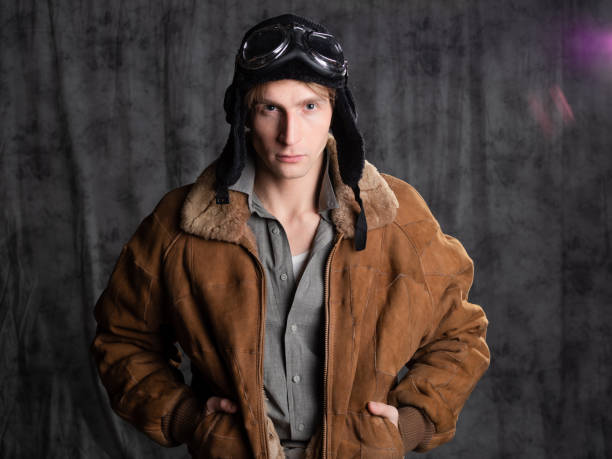 istock Pilot aviator in retro style, a young man in a flight jacket and glasses, 1337875225