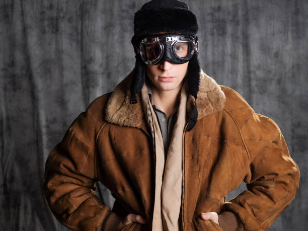 istock Retro style aviator in a flying hat with goggles on his face. 1337875238