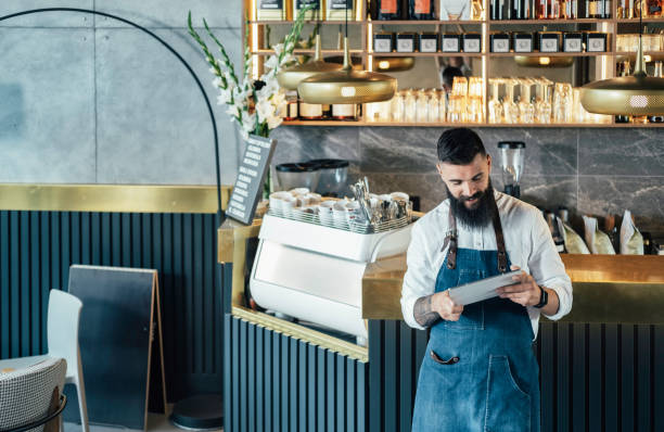 istock Happy Barista Using Digital Tablet in a Cafe 1337879018