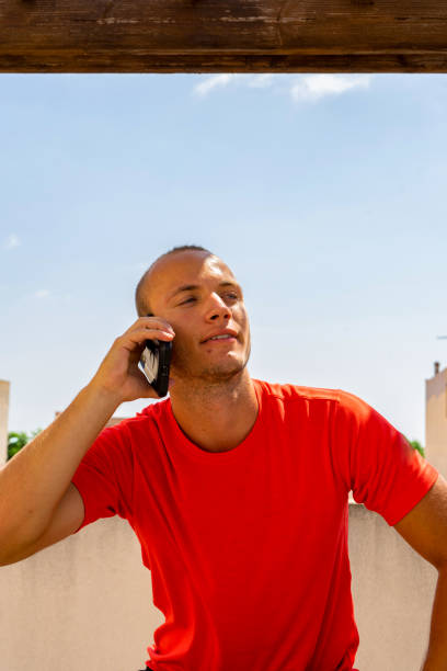 istock Attractive young caucasian man talking with his smartphone outdoors. Technology concept 1337879622