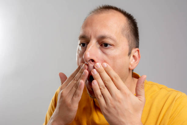 istock man touching his smooth face after shaving. 1337879648