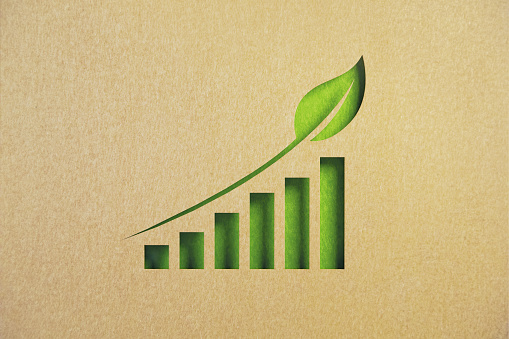 Cut out bar graph on green background. Horizontal composition with copy space. Sustainability concept.