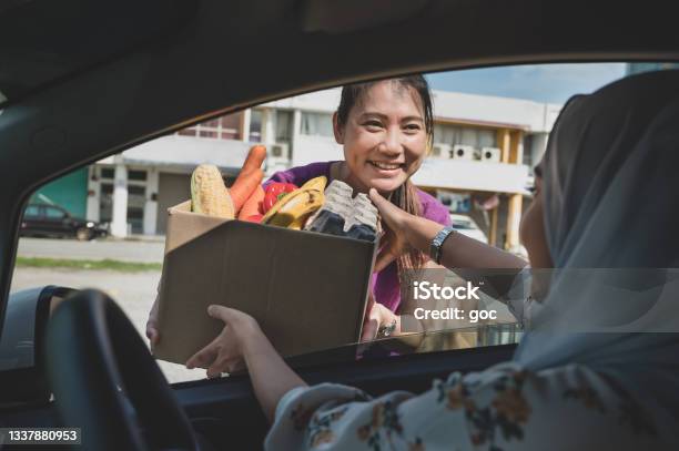 Volunteers Hands Out Food At Drive Through Food Bank Stock Photo - Download Image Now