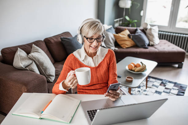 istock Modern senior woman scrolling through social media while working 1337881447