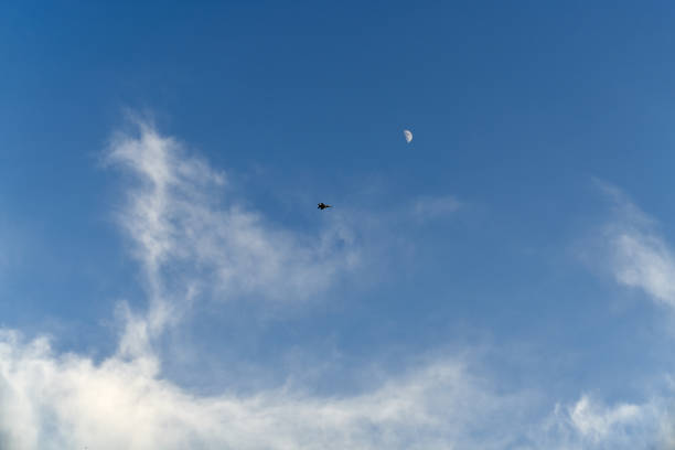 Beautiful blue sky with plane flying on distance. Natural background wallpaper. Calmness atmosphere during summer weather.