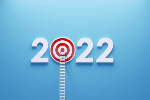 istock 2022 Resolutions Concept - White Ladder Leaning on A Red Bull's Eye Target and 2022 Written by Numbers on Blue Wall 1337883906