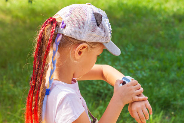 istock Kid using smartwatch outdoor. Child talking on the smartphone. Schoolgirl using touchscreen on watches browsing internet 1337884149