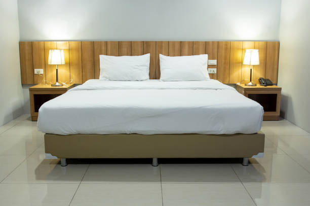 istock Modern bedroom interior with white pillow and table lamp 1337885826