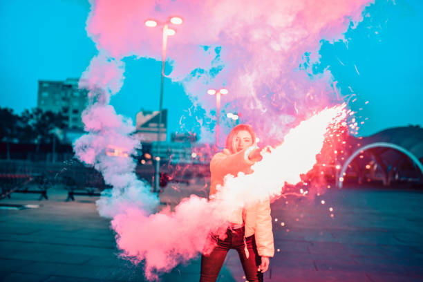 istock Beautiful Female Playing With Red Flares Outside 1337889219