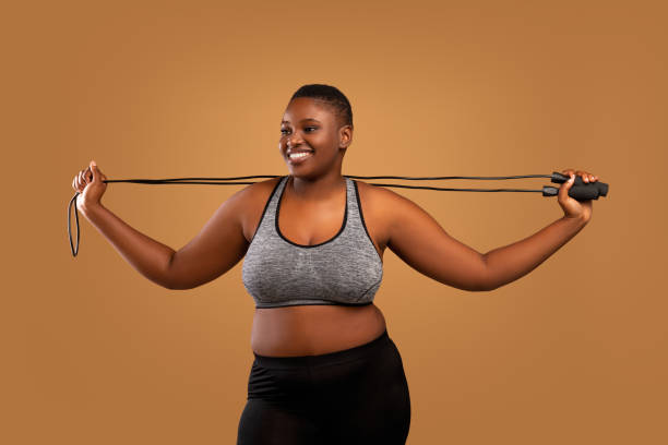 istock Young Black Chubby Woman Posing With Jumping Rope At Studio 1337889281