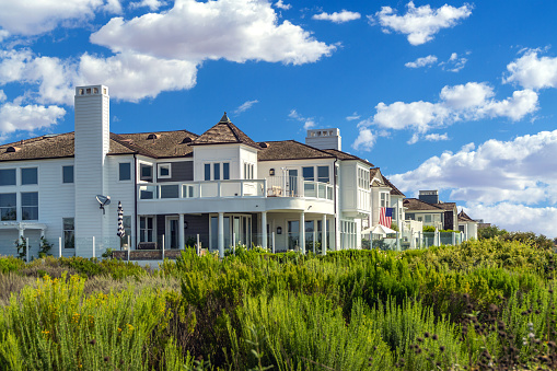Newport Beach, CA, USA – August 12, 2021: Beautiful Cape Cod style houses in the Castaways Park area in Newport Beach, California.