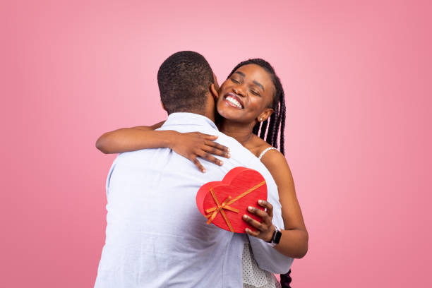 istock Happy black man making surprise for woman giving box 1337891729