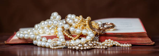 istock White and gold pearls on an old vintage book 1337893715
