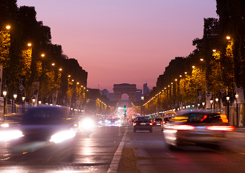 Traffic along the Champs Elysee at dusk in Paris, France.