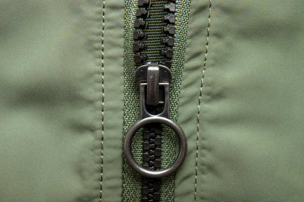 istock Metal zipper on nylon texture, closeup or macro view. Fastener on jacket 1337895837
