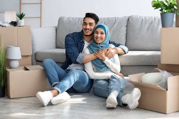 istock Beautiful middle-eastern couple resting while unpacking after moving 1337897698