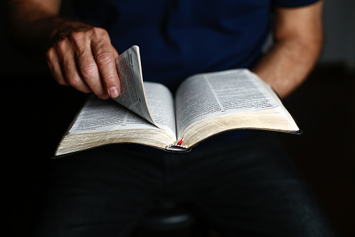 A man opening the bible with his hands