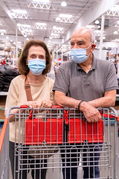 istock senior couple shopping wearing protective face masks 1337899230