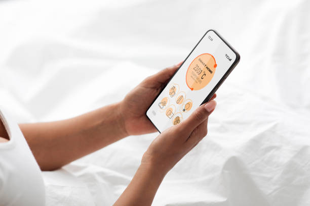 istock Woman regulating room temperature via smart home, using smartphone 1337905029