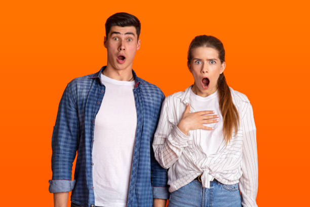 istock Young surprised couple with open mouths looking at camera 1337905404