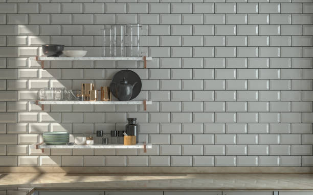 istock Front view kitchen with marble kitchen countertop under warm morning sunshine, white ceramic alternating tiles wall, and wall hung kitchen shelf various kitchenware on it, 3d Rendering 1337907707