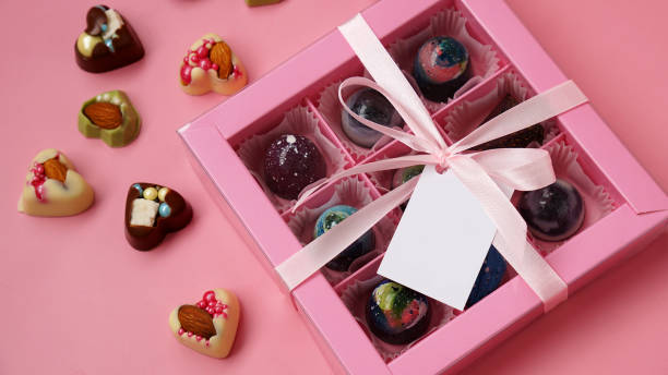 istock Chocolate candy. Pink gift box with handmade chocolates on pink 1337909382